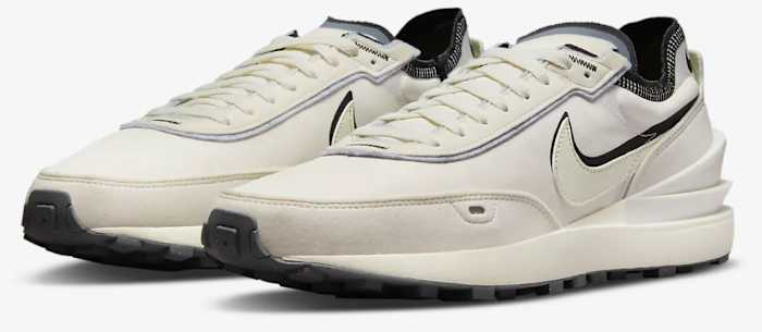 View of tan and black Nike shoes.